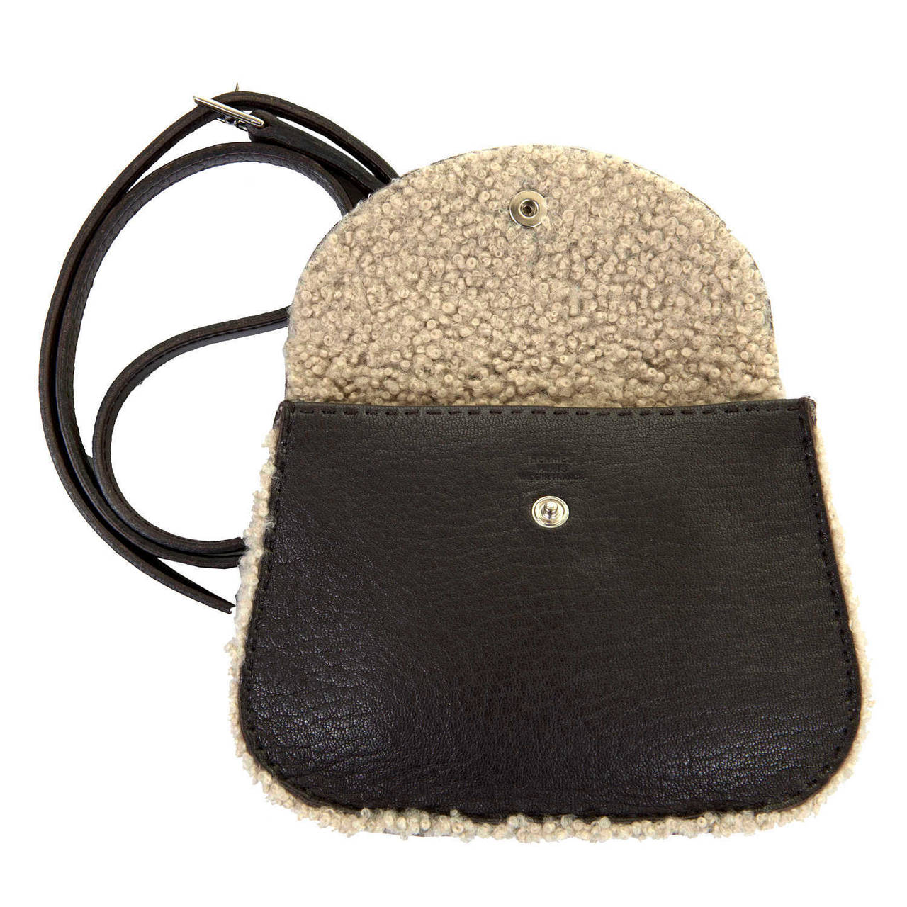 A rare & delightful Hermes Sheepskin Cross-Body or Shoulder Bag. Finished in Chocolate Brown Shearling with Silver Palladium Hardware. The bag with it's adjustable  and detachable strap, can be worn as a Clutch or a Shoulder or Cross-Body bag. The
