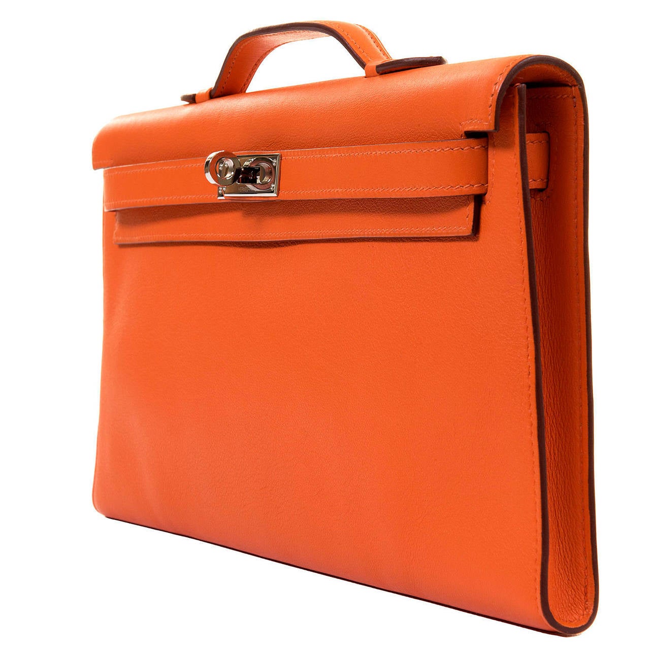 A sensational orange 'Cut Kelly' Clutch Bag in Veau Swift leather with Silver Palladium Hardware, in pristine 'Store-Fresh' condition. From the Hermes 2007 collection, the bag has a matching leather interior with an open side pocket, with the inside