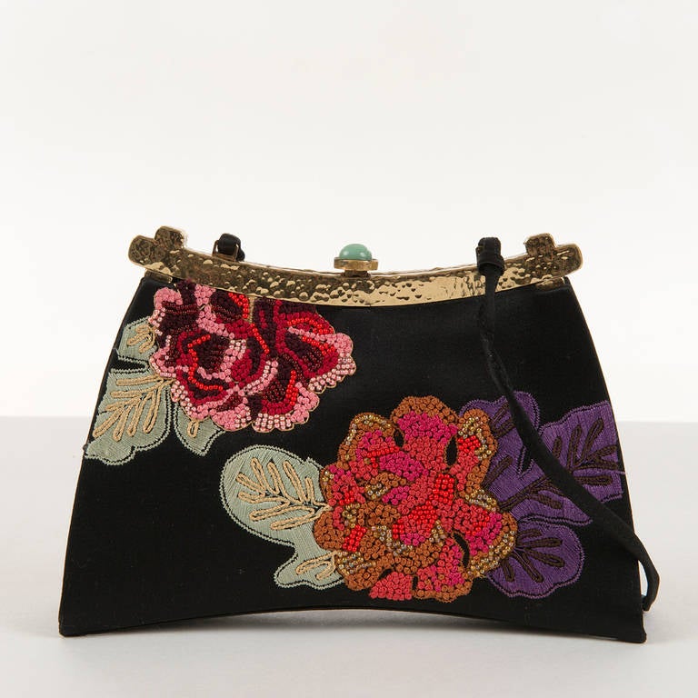 An absolutely Stunning  & Unique Evening bag by Josie Natori. This New York designer has been established for over 35 years, and her attention to detail is legend. This beautiful satin bag is hand embroidered on both sides, with goldtone hammered