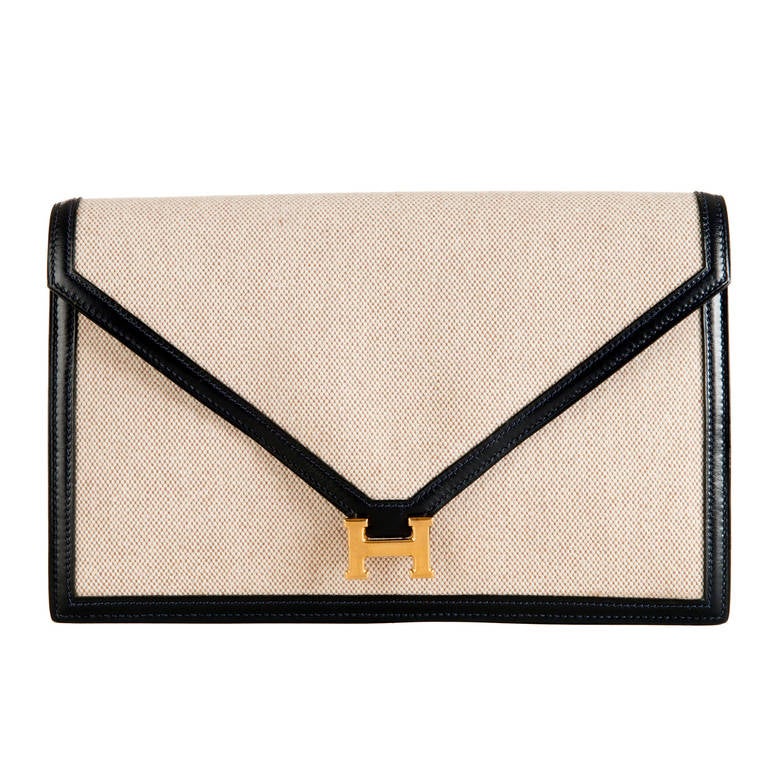 Just the most timeless, elegant Hermes bag. In pristine condition the bag is finished in beige 'Toile' with Navy calf-leather trim with the interior finished in Navy calf leather, with 3 pockets, one zipped. The bag can be a smart clutch or with its