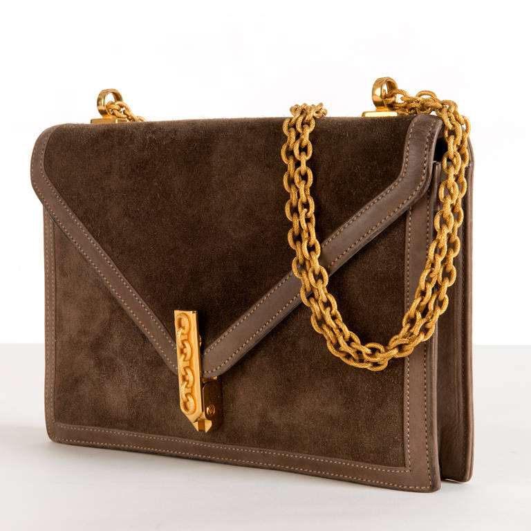 A very smart Hermes 'Alcazar' bag in eyecatching brown suede with taupe, 'Doblis' calf-hide trim. The unique slide-lock clasp is decorated with gold chain links to match the double chain shoulder strap. Complete with it's original dust sac. Hermes