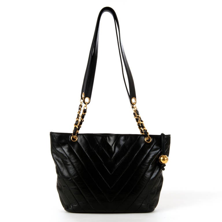 This Very Chic, Large Chanel, Double Handled, Shoulder Bag is finished in soft, black lambskin hide, with the Chanel 'Chevron' quilted design pattern. Complemented by the Gold-tone Hardware together with it's iconic 'Globe' - Double 'C' zip pull,