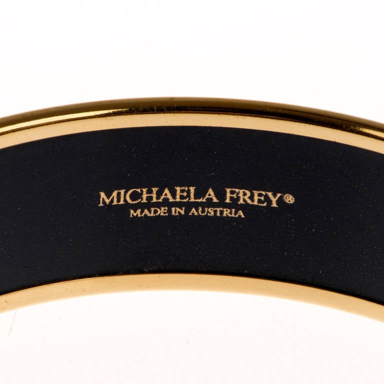 This fabulous Michaela Frey Bangle, was made at her workshop in Vienna around 1960. Michaela Frey was the designer and manufacturer of choice for Hermes, Paris and this Gilt Bangle, inlaid with enamel abstract designs, is a typical Hermes design, in