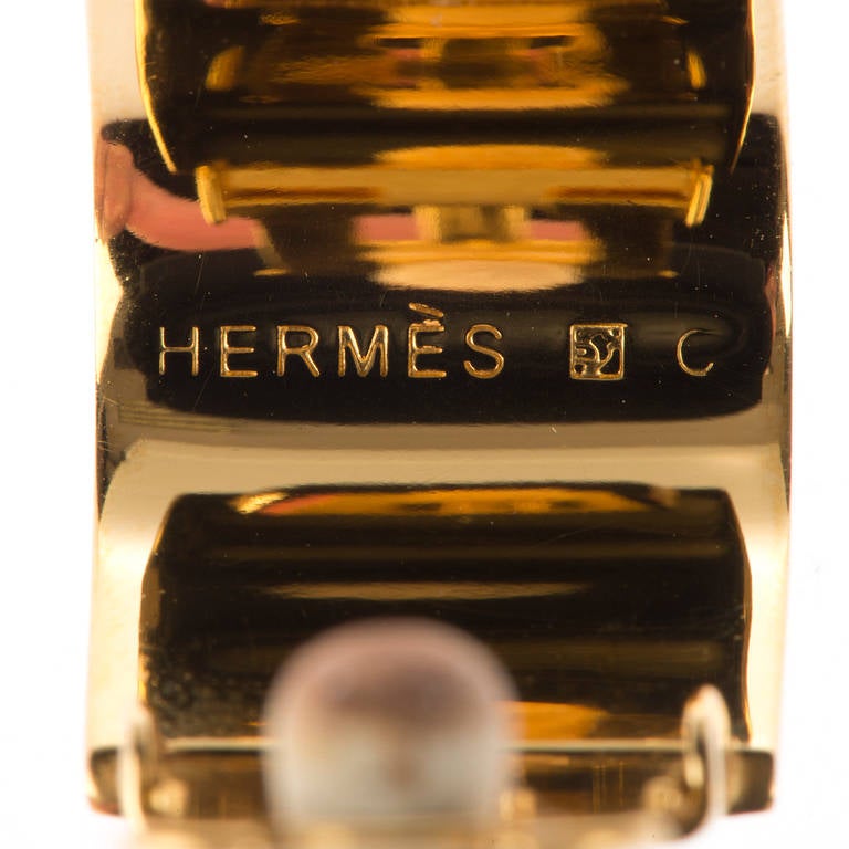 A Fine pair of exquisite Hermes, vintage, clip-on earrings. The gold-tone metal is delicately inlaid with floral enamel panels, with the craftsmanship being of the very highest order, as you would expect from Hermes. In pristine condition the