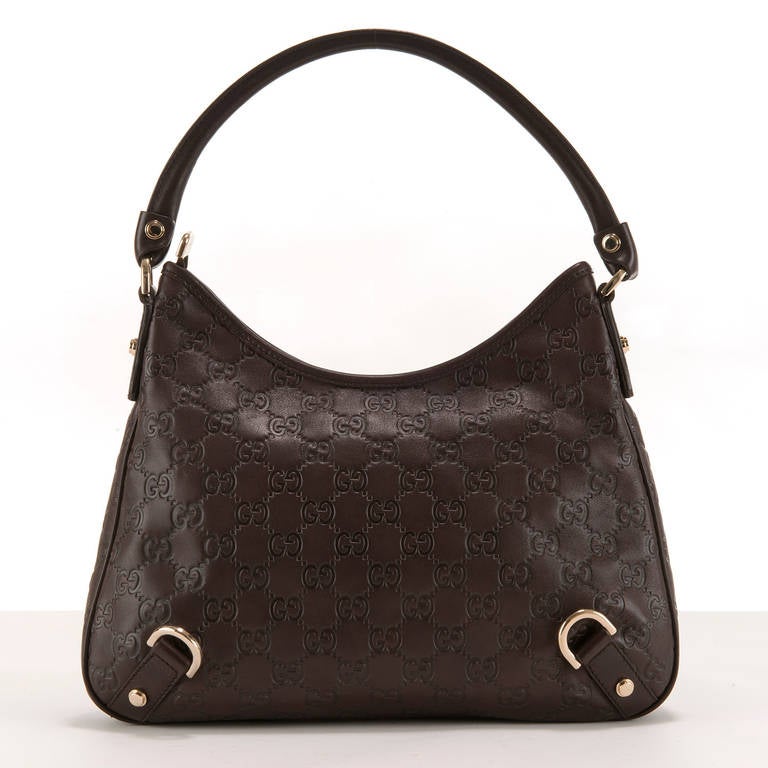 A very Stylish Chocolate Brown Leather, Gucci, 'Hobo' Bag, the leather embossed with the famous Gucci logo. With silver paladine fittings and a zipped closure, the interior lining is also embossed with the Gucci logo. In pristine, almost new