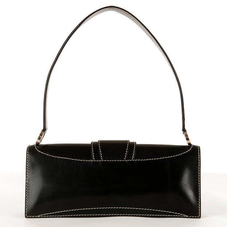 A really unusual & stunning Celine black shoulder bag, that can be used as a large clutch or evening bag. The striking design is very chic and the white 'saddle stitching' really works with the black box leather. Complemented by the silvertone