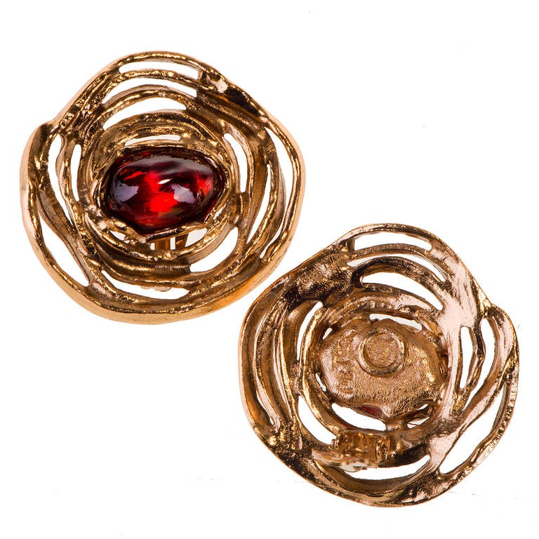 These very stylish gilt-metal clip-on earrings, are centered with the most amazing Ruby-red, oval cabochon, cut glass stones. Bearing the 'YSL