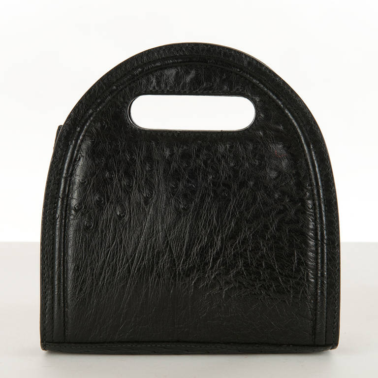 A great clutch, handbag or shoulder bag by Gucci, in gorgeous black Ostrich-skin. Small in size but big with the WOW ! factor. This unique bag is unrepeatable and at an unrepeatable price !!  It will become one of your favorites. The black suede