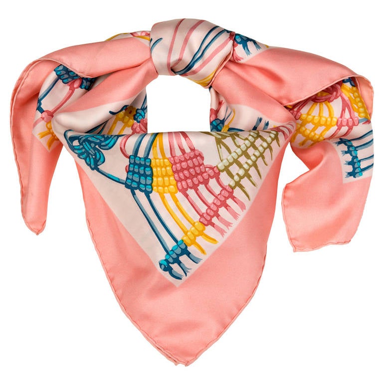A simply gorgeous Hermes printed silk scarf, 'Macrame'. With it's unusual subject matter and delightful pastel shades, this is a must have accessory for any wardrobe.