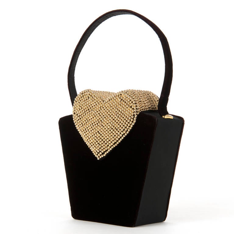 Made in Paris, this unique, fun evening bag, with the 'heart-shaped' opening flap covered in gold beads, perfect if you wear 