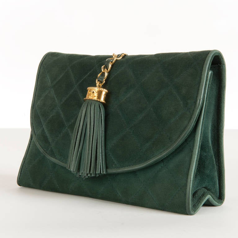 A gorgeous Forest Green quilted lambskin, suede 'Tassel' Clutch bag by Chanel. The signature goldtone chain and fitting, styled with the Iconic double 'C' Logo is fitted with a cut-leather matching tassel. The black leather interior has a zipped