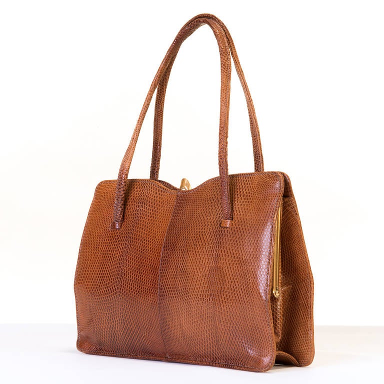 A Fine, English made Tan Lizard Handbag, circa 1960, by Golden Arrow. With a matching suede interior and goldtone hardware, the bag, considering it's age is in excellent condition.