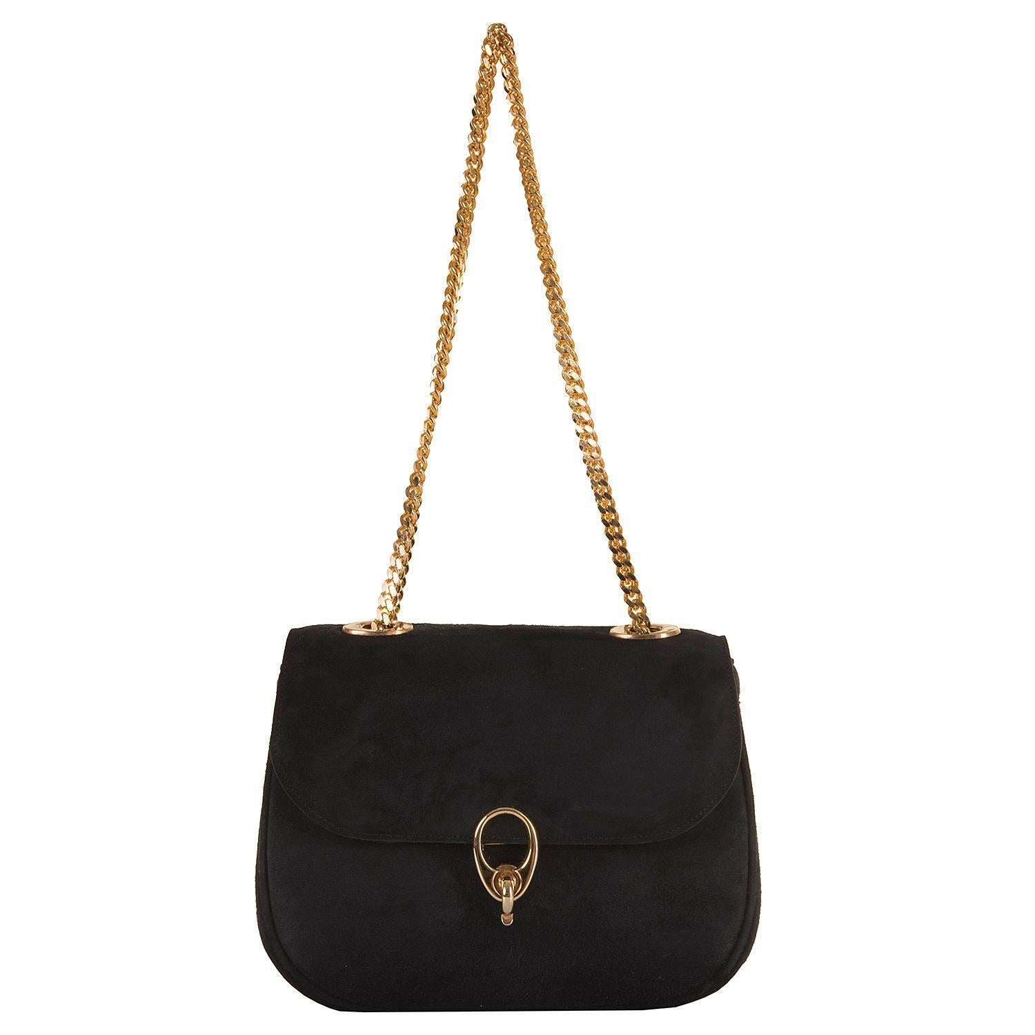 This classic beautiful vintage shoulder bag by Celine of Paris, is finished in black calf-suede with gold-tone hardware. Of superb quality, the double chain-link handles are complemented by Celine's iconic latch-clasp. In superb condition, inside