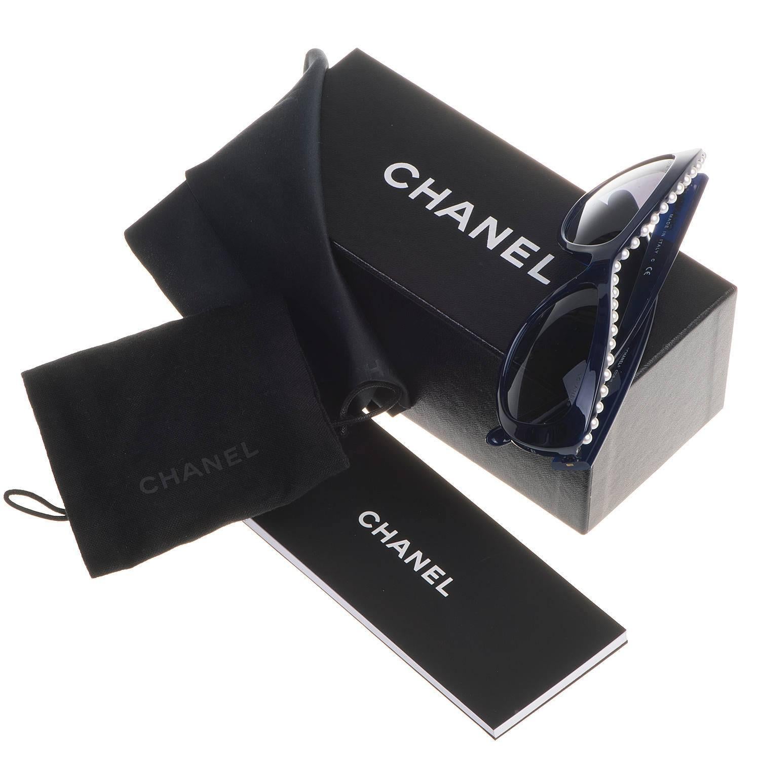 A Pristine pair of Chanel Sunglasses with Blue lens and faux pearl inlays to the top of the frame. Signed and still with their original box and lens cleaner.