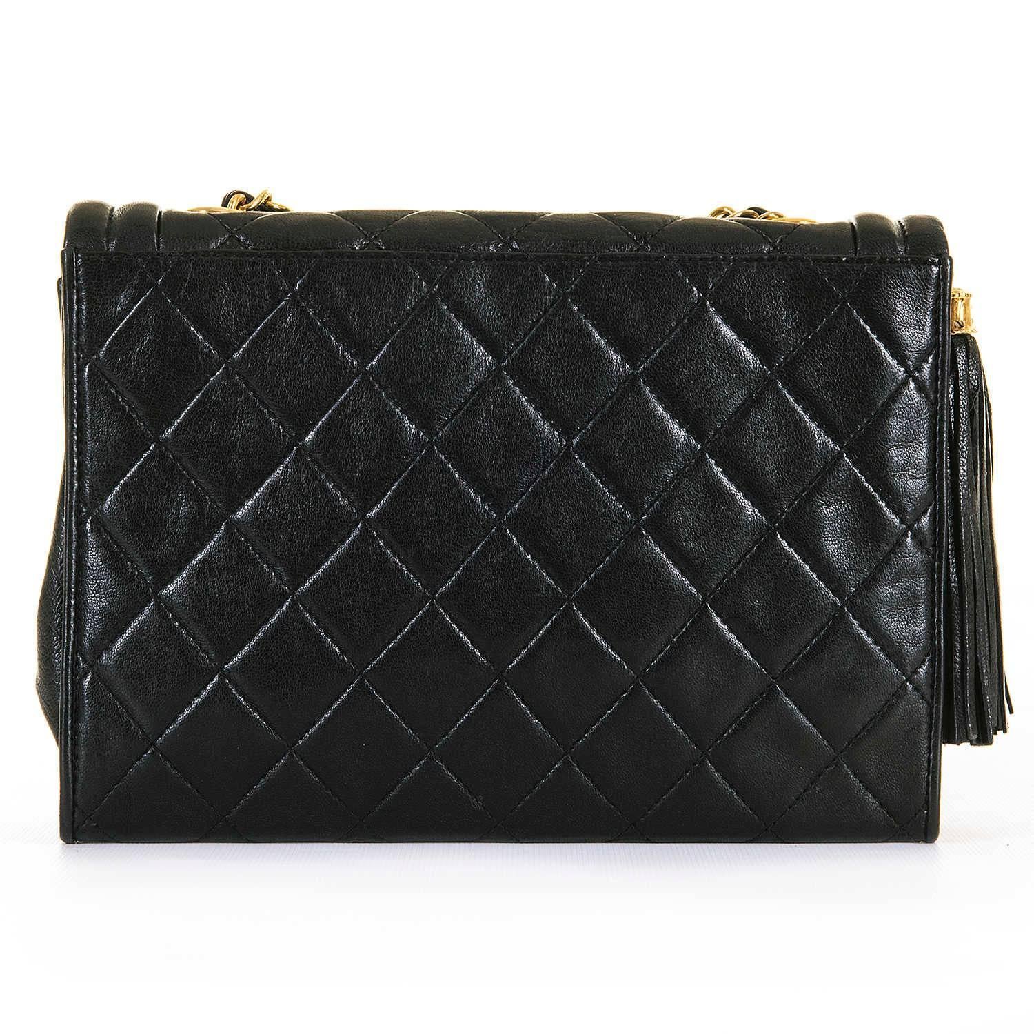 A Very Rare Vintage Chanel Black Quilted Sac 'Pompom' Lambskin, Shoulder Bag. In pristine condition, throughout, the bag has a double-piped flap with a magnetic clasp, together with a leather fringed 'Pompom' with a finely cast gold-capital, with