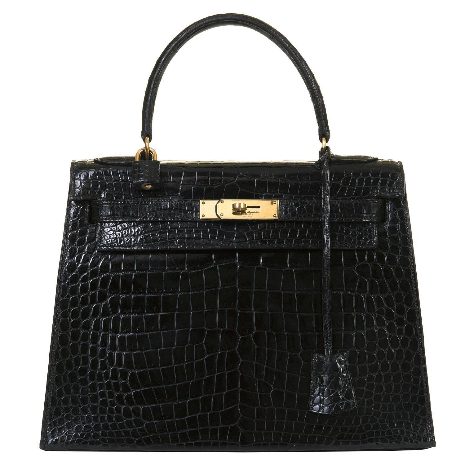 This SO SO RARE Vintage Hermes Black kelly Crocodile Bag with Goldtone Hardware is in absolutely Pristine condition, throughout, including the hardware. The inside is finished in Black Chèvre leather and the bag comes complete with it's padlock,