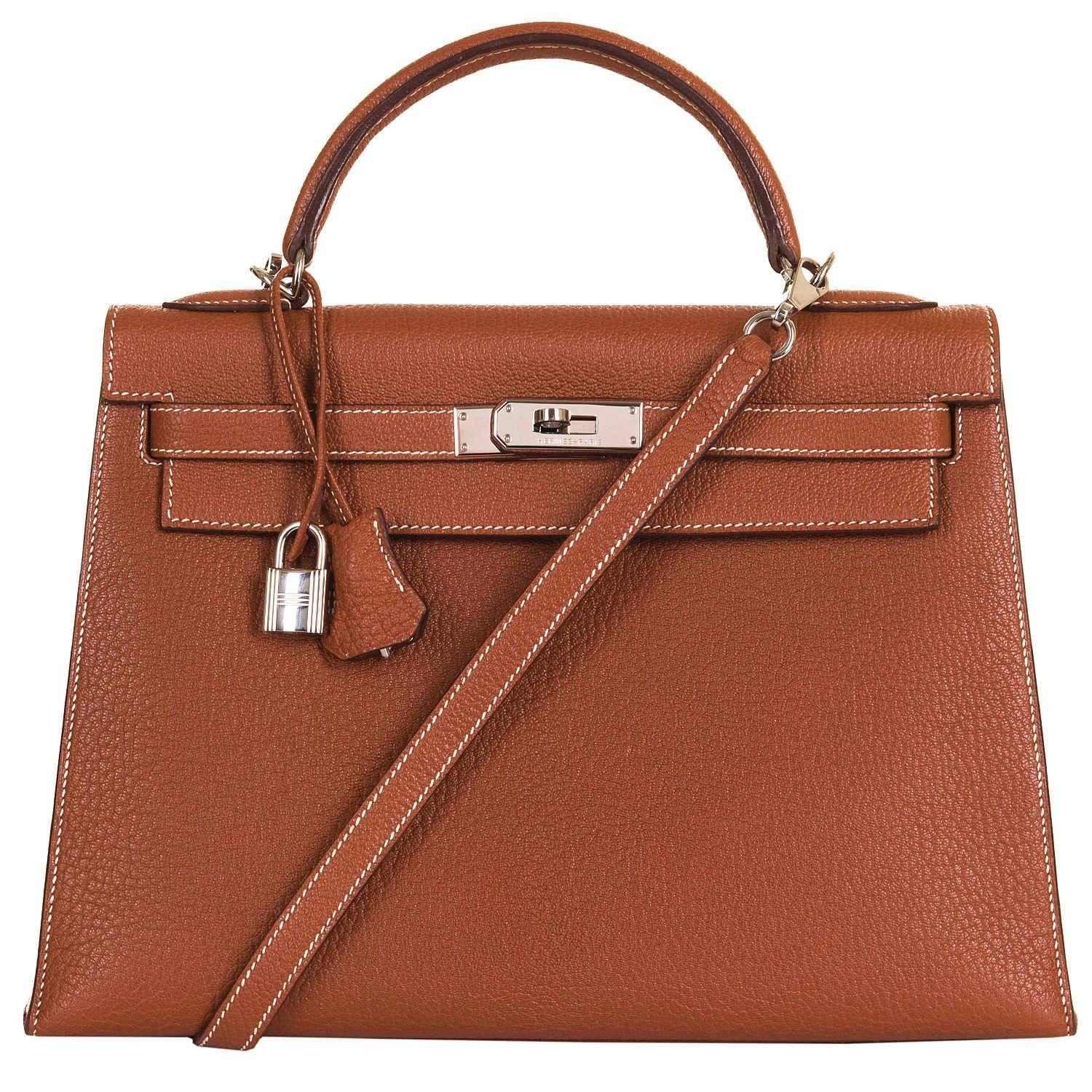 Never worn - This Absolutely Pristine Hermes Kelly 32cm Sellier Bag is finished in Rust brown - 'Rouille' Clemence Leather with Silver Palladium Hardware. The interior has a full length zipped pocket and two half-width open pockets and is finished