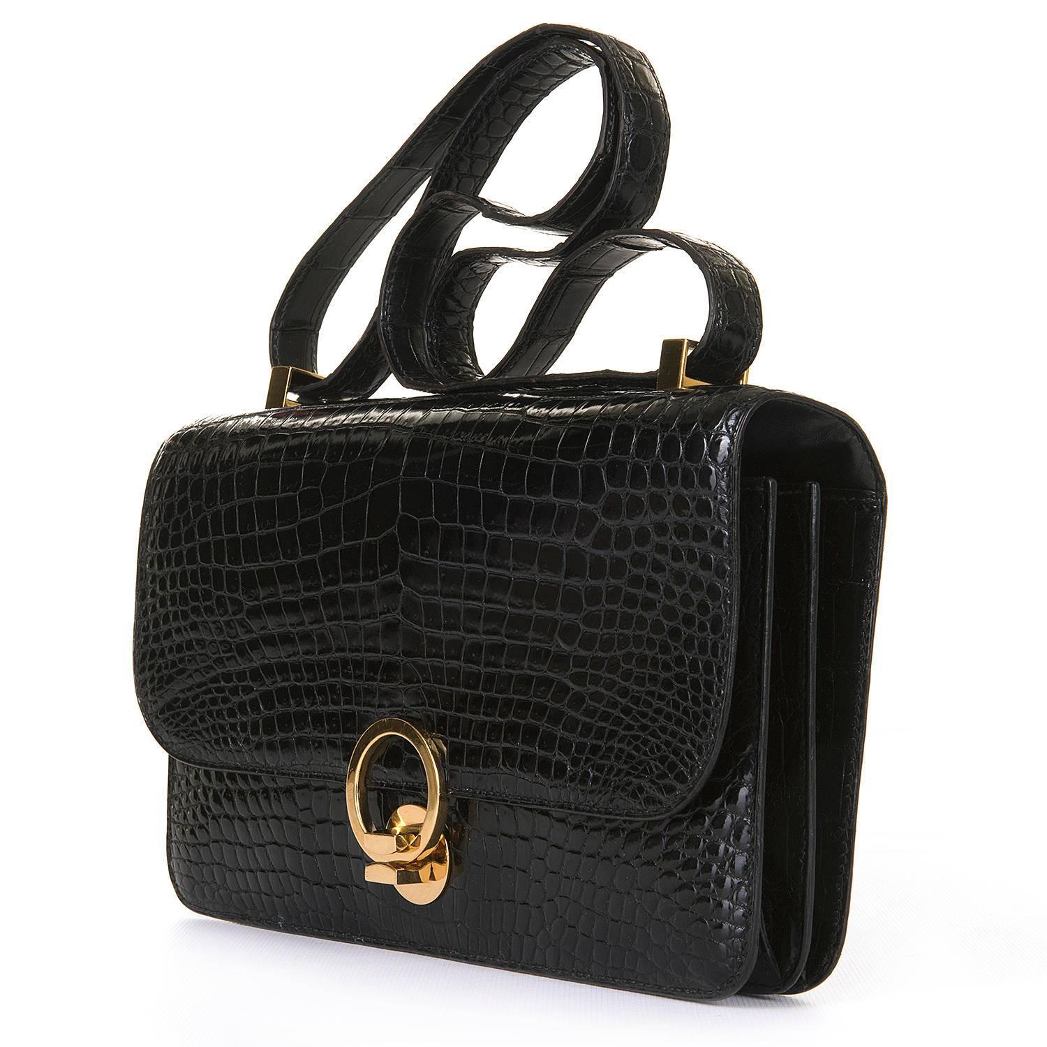 An Absolutely Stunning Vintage Hermes 'Sac Ring' Shoulder Bag finished in Black Crocodile with Gold Hardware. This rare Hermes Bag was styled on the coveted Hermes Constance bag and is the same size and shape with an identical 'Double-up' Shoulder