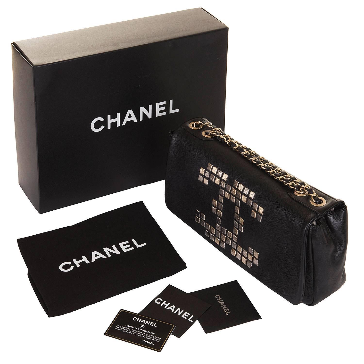 A rare & unusual Chanel jumbo-sized black lambskin leather, 'Mosaic', shoulder or clutch bag, featuring the iconic 'CC' logo to the front flap of the bag, formed from gold & silver engraved metal squares. The double handle strap can be