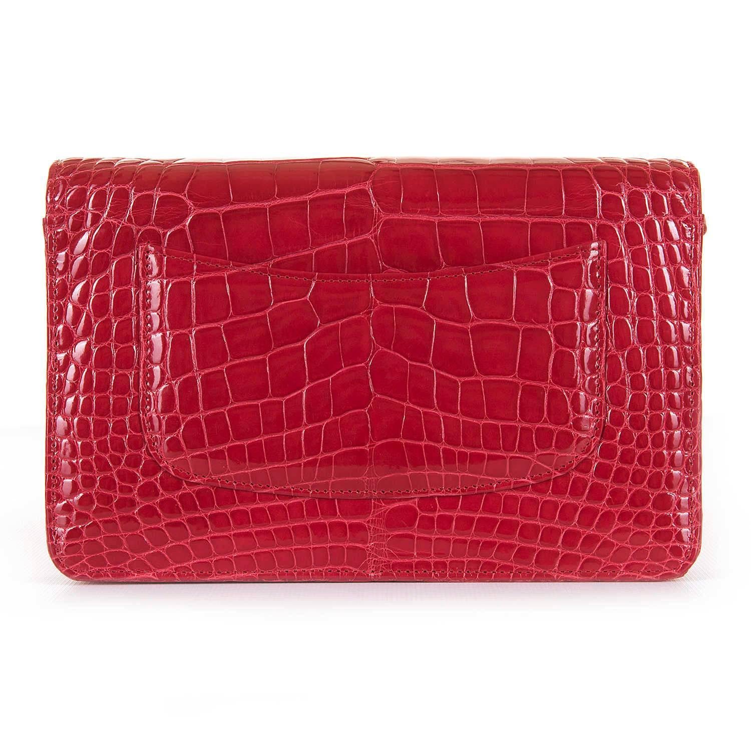 A very rare Chanel bag in the most desirable colour finished in expensive, sought-after Alligator Leather. This Imperial Red, Alligator WOC is beautifully complemented with tres chic silver palladium hardware. The inside is fitted with multiple