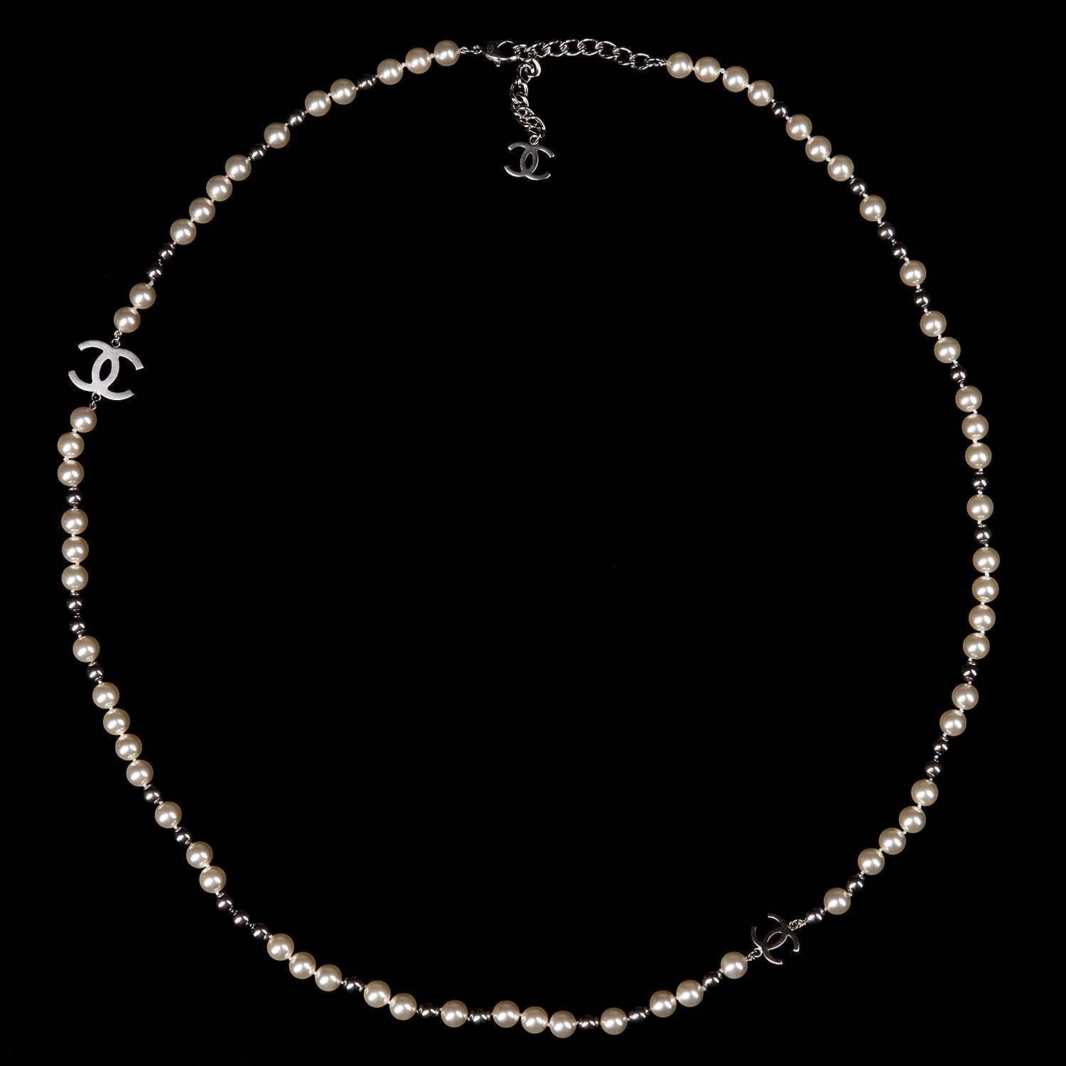 This Chanel necklace is such a beautiful elegant piece. Never worn it is in absolutely pristine condition. The large faux pearls are indispersed with smaller silver baubles embellished with two, a large & small Chanel 'CC' silver logo. It comes with