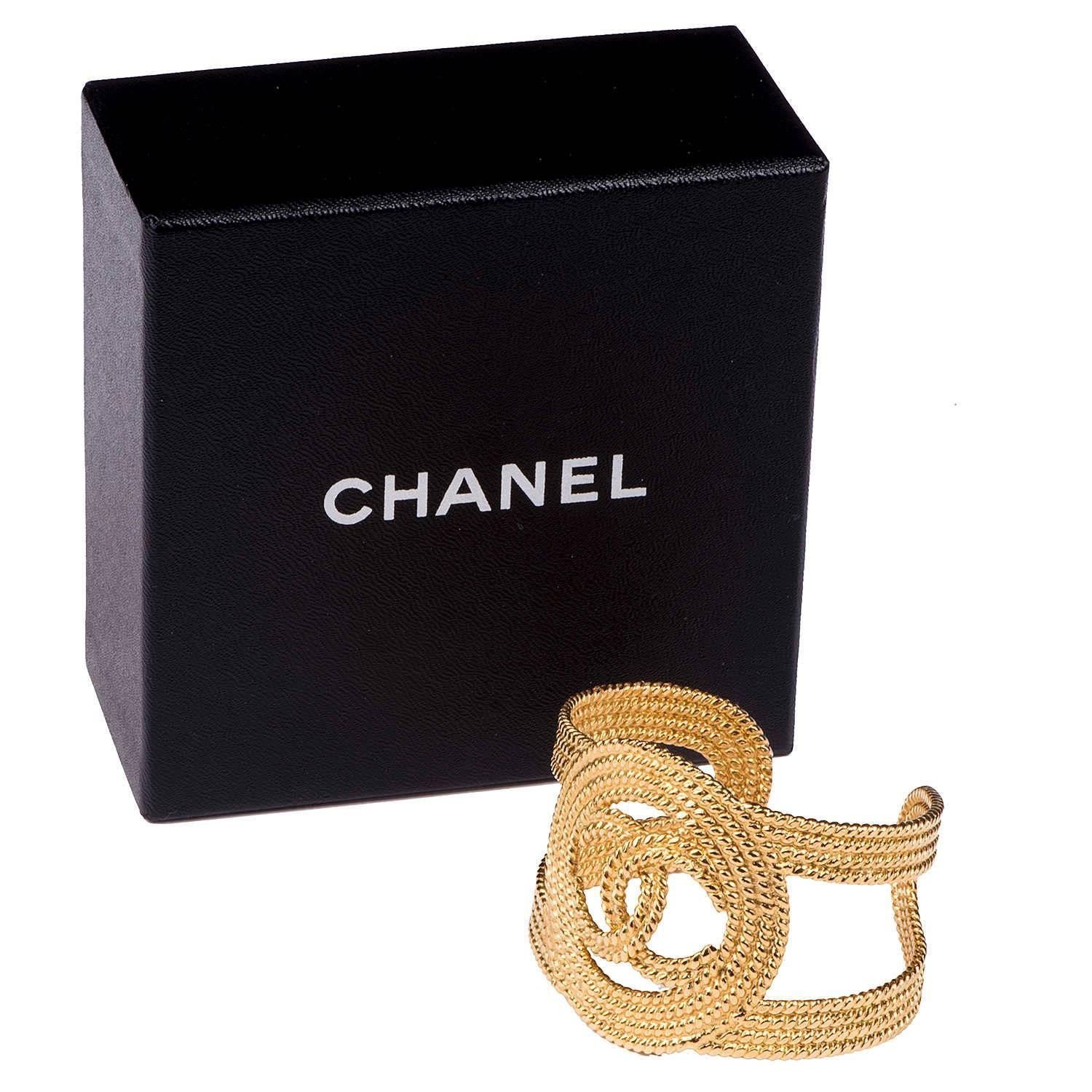 A real statement piece!! A Chanel braided gold cuff, centered with the classic interlocking 'C' Chanel Logo. This fabulous 'cuff' bracelet is in pristine condition and comes with it's original Chanel gift box.