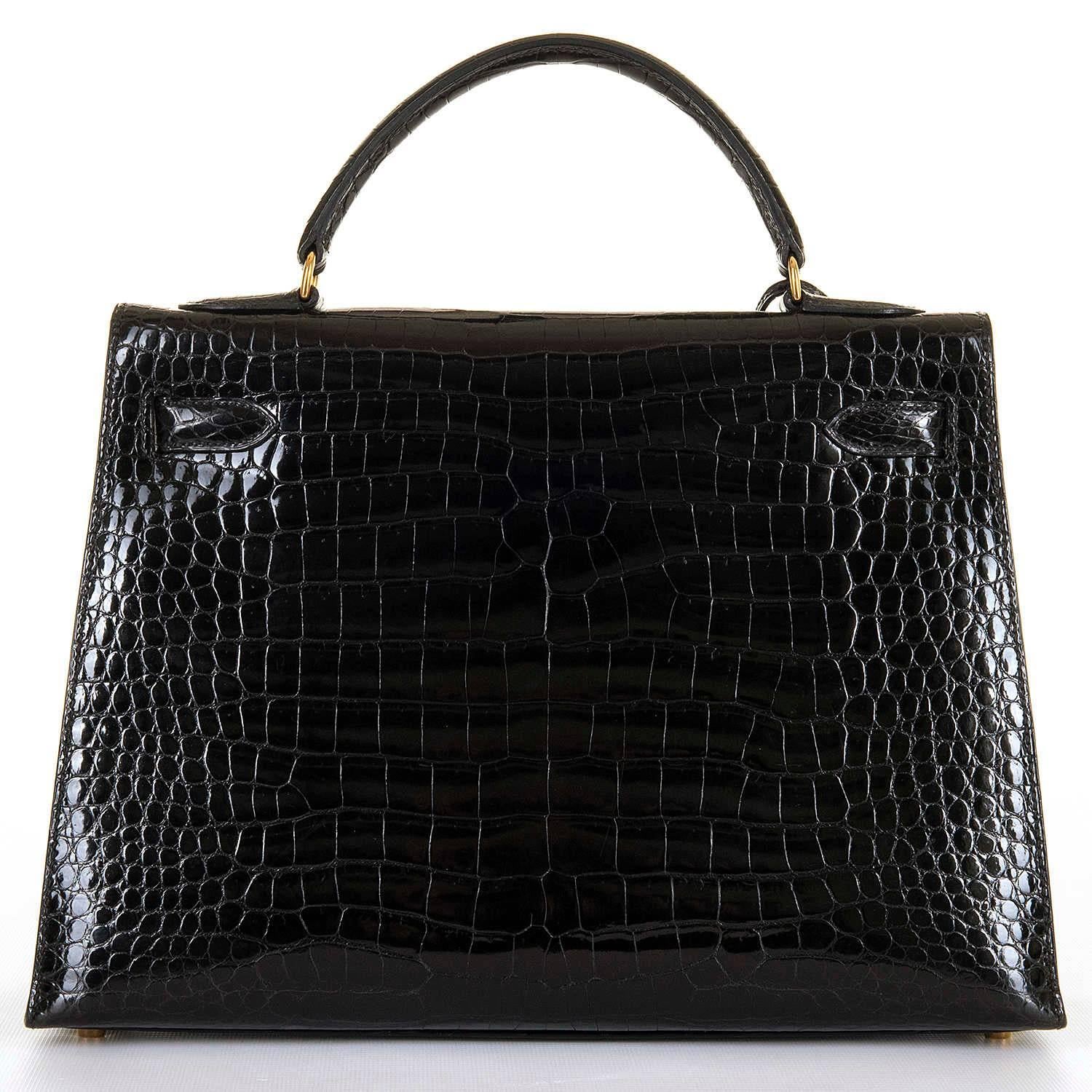 This Rare Hermes 32cm Black Crocodile Kelly Bag with Goldtone Hardware is in 'As New', pristine condition throughout.The interior is finish in Black Chèvre leather and has a full length zipped pocket, with open pockets to the other side. Fitted