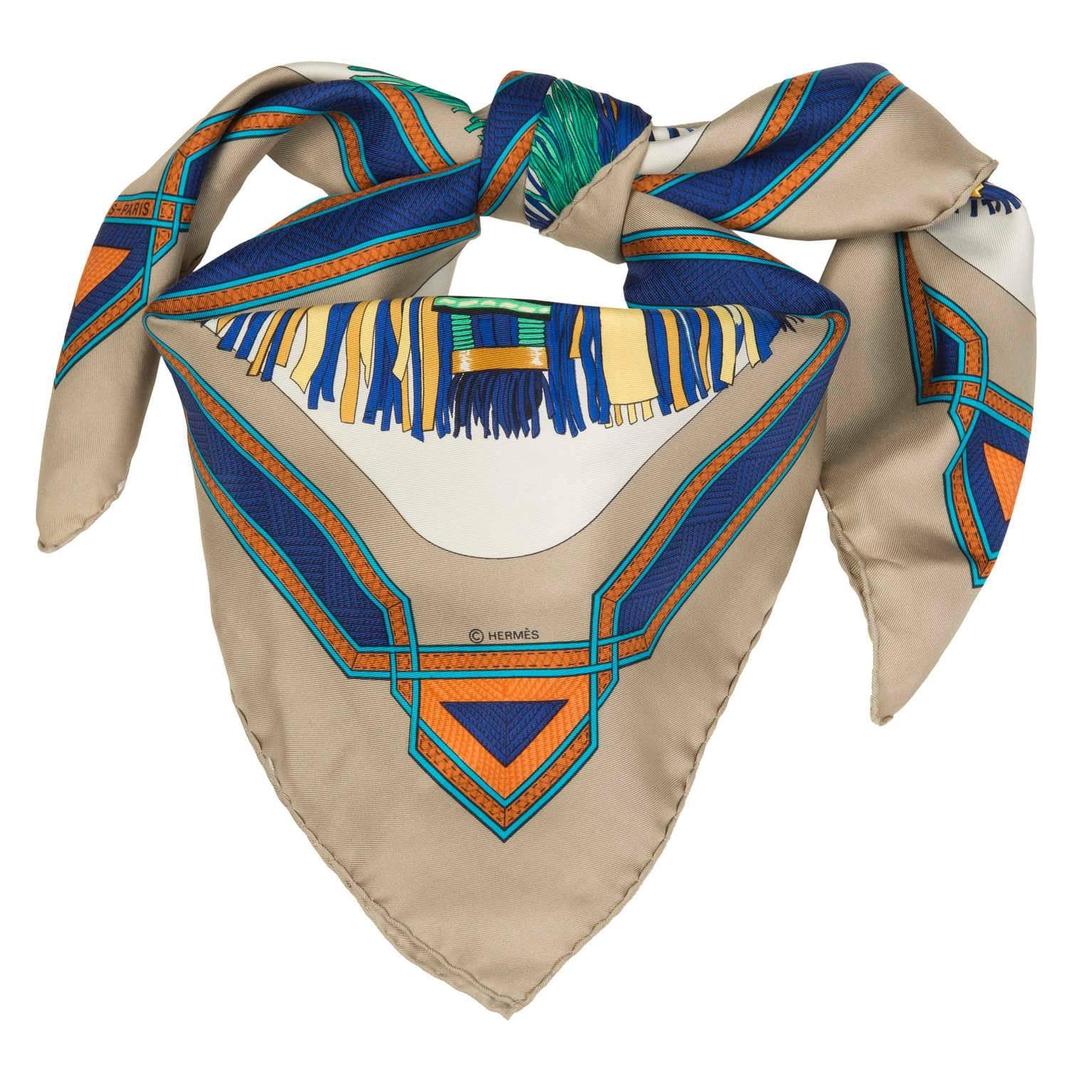 A rare & beautiful vintage Hermes scarf - 'Cuirs du Desert'. The scarf designed by Francoise de la Perriere in 1988, depicts the brightly coloured leather head decoration that the Bedouin tribesman used to adorn their Camels with.  Now highly sought