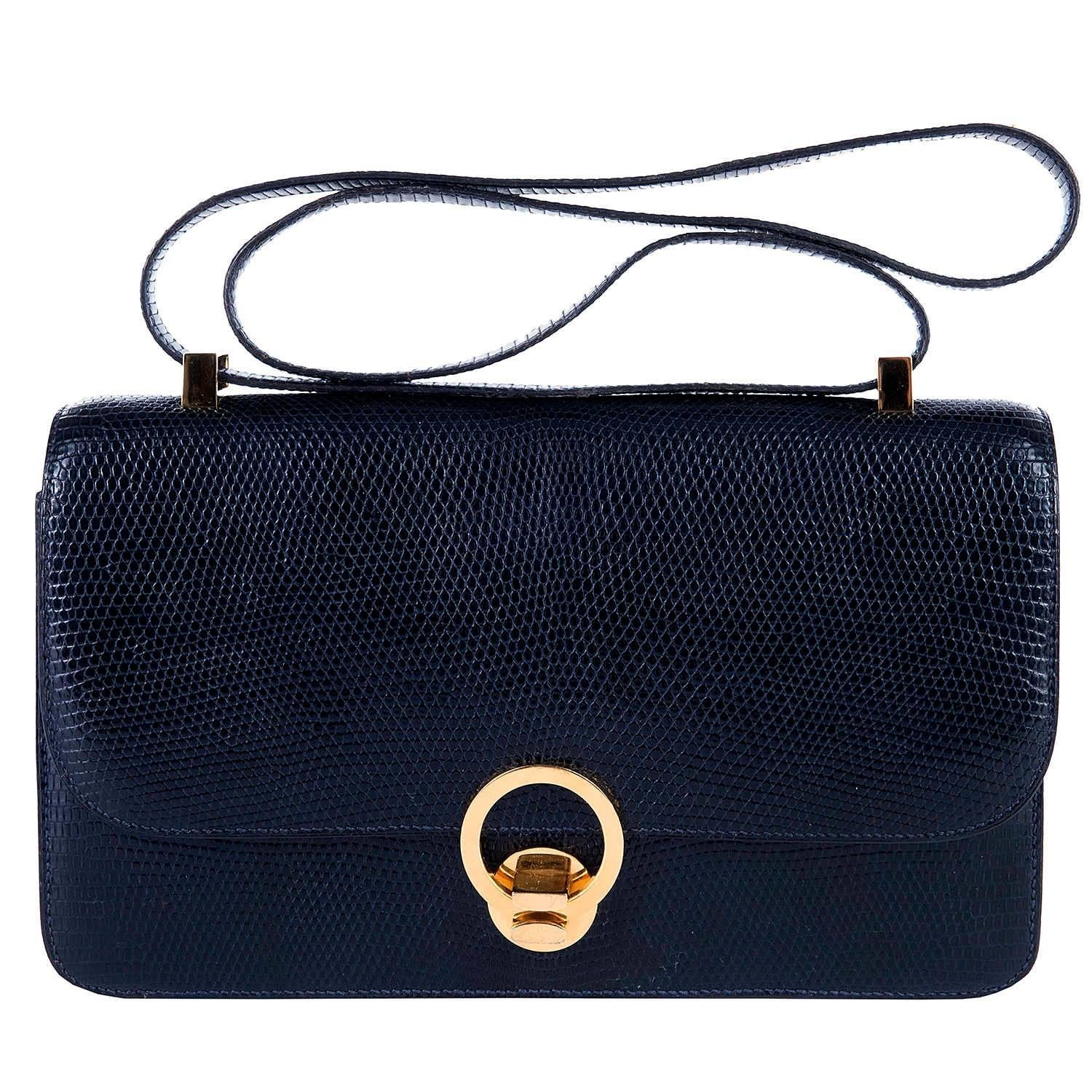 An Absolutely Stunning Vintage Hermes 'Sac Ring' Shoulder Bag finished in Navy Blue Lizard with Gold Hardware. This rare Hermes Bag was styled on the coveted Hermes Constance bag and is the same size and shape with an identical 'Double-up' strap. In