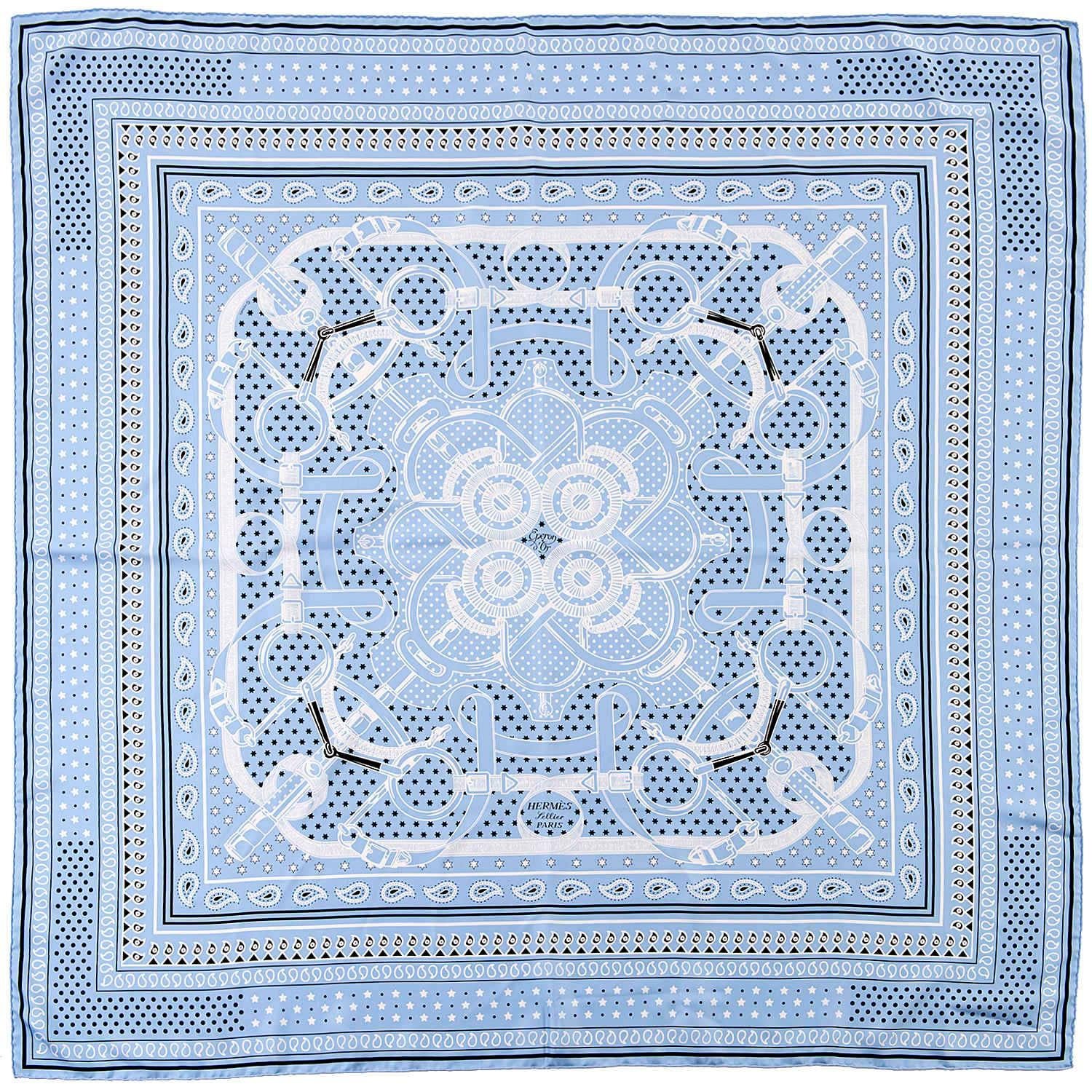 Pure Luxury. This gorgeous Hermes Silk Shawl, 'Eperon d'or Remix' by the legendary Hermes designer Henri d'Origny, was first released in 1974 and is in pristine 'store-fresh' condition. The light blue ground is highlighted with black and white