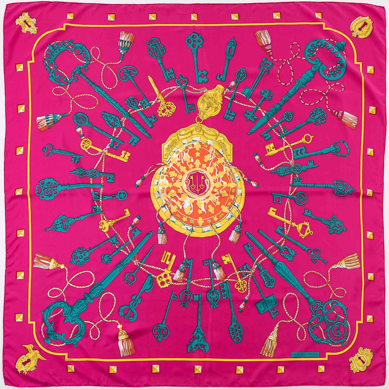An absolutely stunning silk Shawl by Hermes - 'Les Clefs' by one of Hermes favourite designers, Caty Latham is finished with sumptous rich colours - yellow, orange, emerald green, white on a fuchsia ground and make this a stand out piece. In