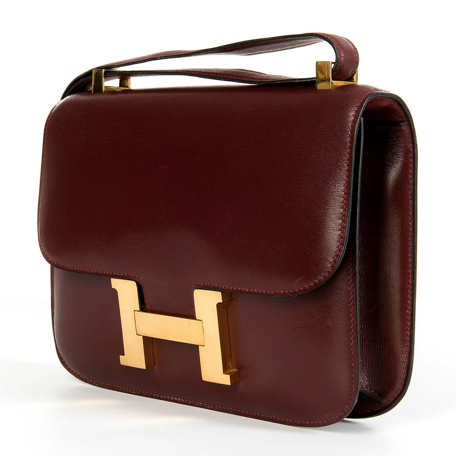 An absolutely stunning Hermes Constance bag finished in 'Rouge H' Box Leather with Gold hardware. The Constance bag was originally designed in 1959, by the legendary Hermes Designer, Catherine Chaillet, and named after her 5th child. This 'Tres