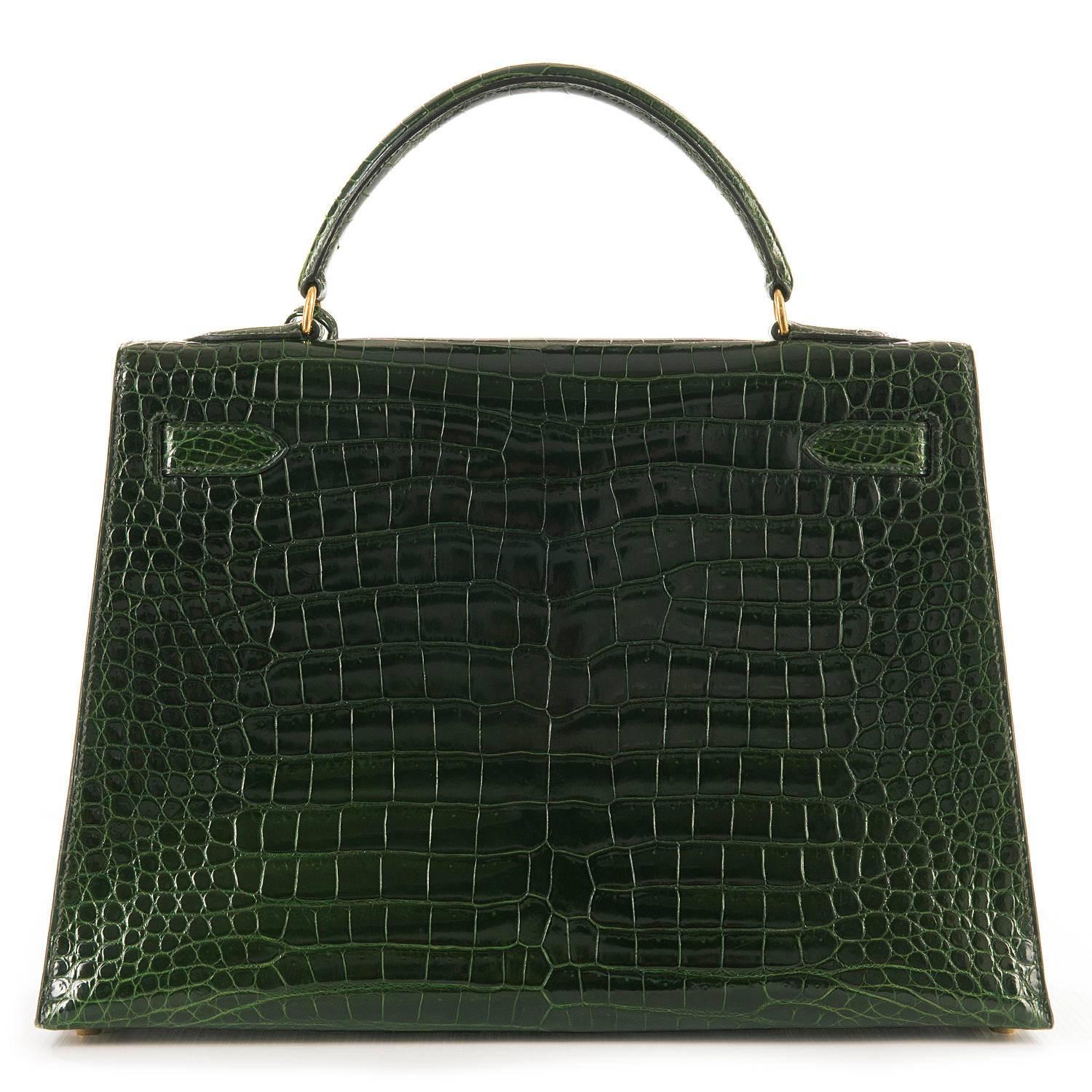 Simply the most stunning Hermes 32cm Shiny Crocodile Kelly Bag. In exclusive Emerald Green with Gold Hardware, the bag is in absolutely pristine, 'As New' condition and comes complete with it's shoulder strap, key-fob & keys, padlock and