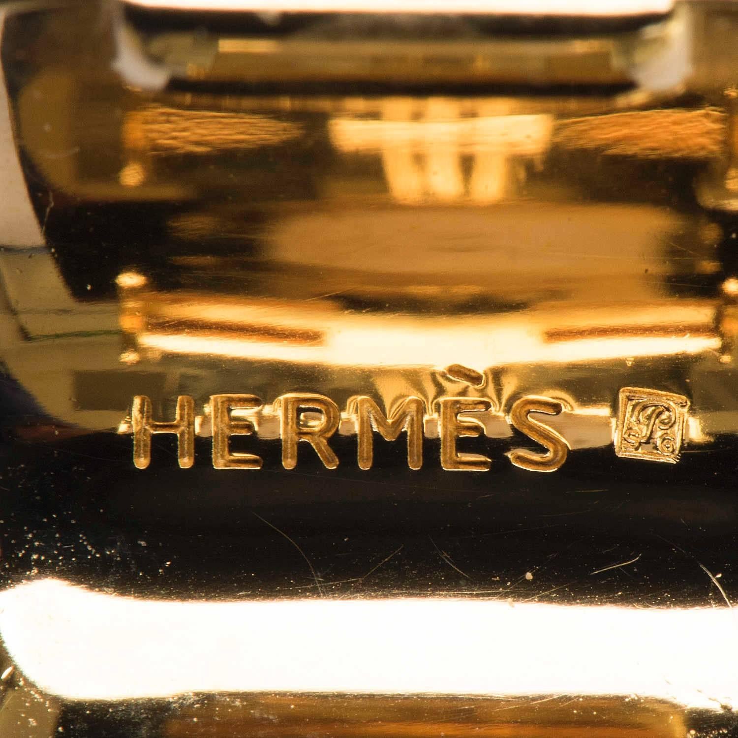 Timeless, Elegant Hermes ! This superb pair of clip-on Earrings are beautifully finished in gold-metal with finely worked enamel. In pristine condition and both bearing the Hermes makers mark, each earring is uniquely different with one depicting an
