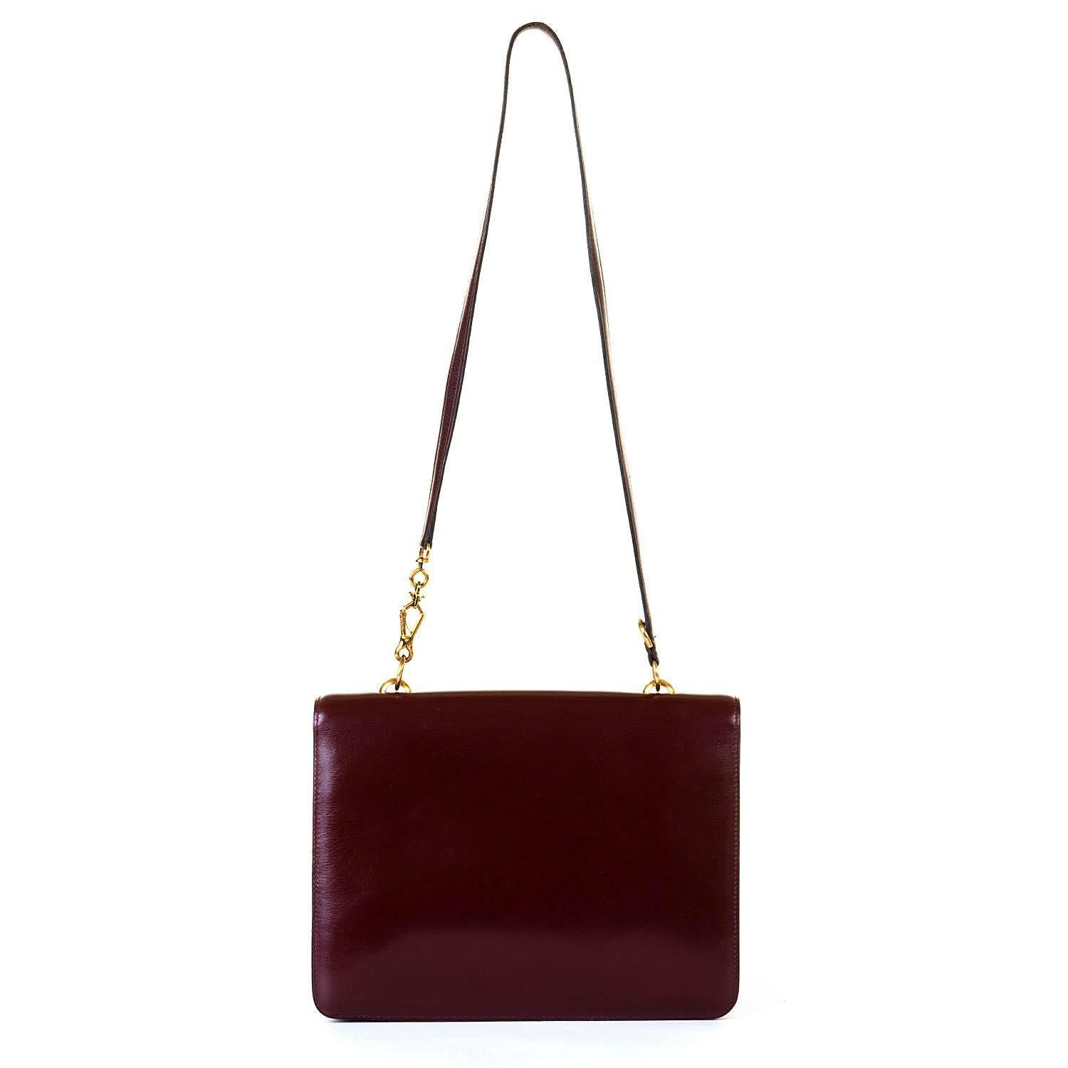 A stunning Vintage Hermes 'Sac Sandrine'  Shoulder bag, in Burgundy Box Leather with Goldtone Hardware. With it's featured 'stirrup' clasp, the bag, made in circa 1970, is in pristine, 'little-used' condition. Hermes designed this bag in homage to