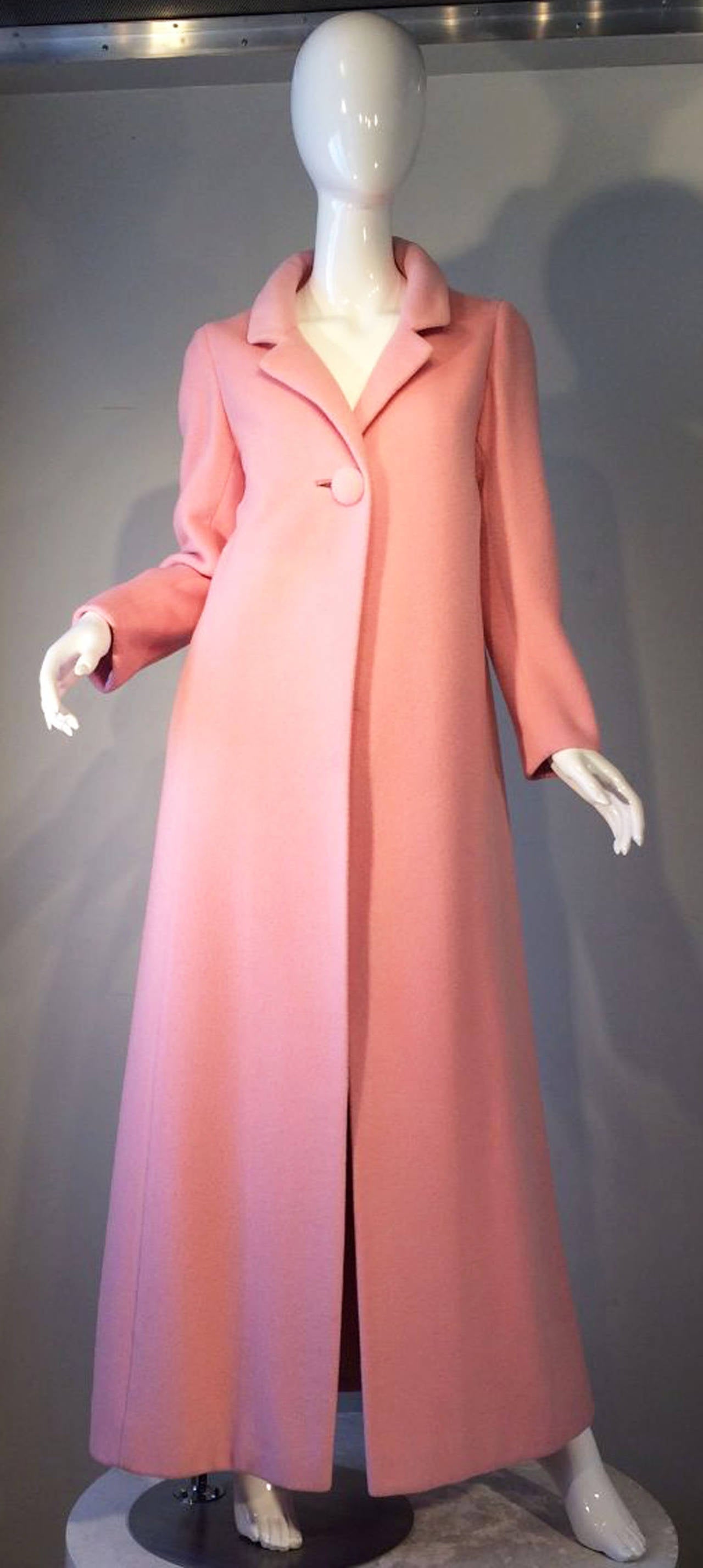 A fine vintage Anne Klein princess length coat. Early AK design for Junior Sophisticates circa 1965. Pale pink wool item fully silk crepe lined with single matching fabric covered button closure. A charming example of American sportswear influenced