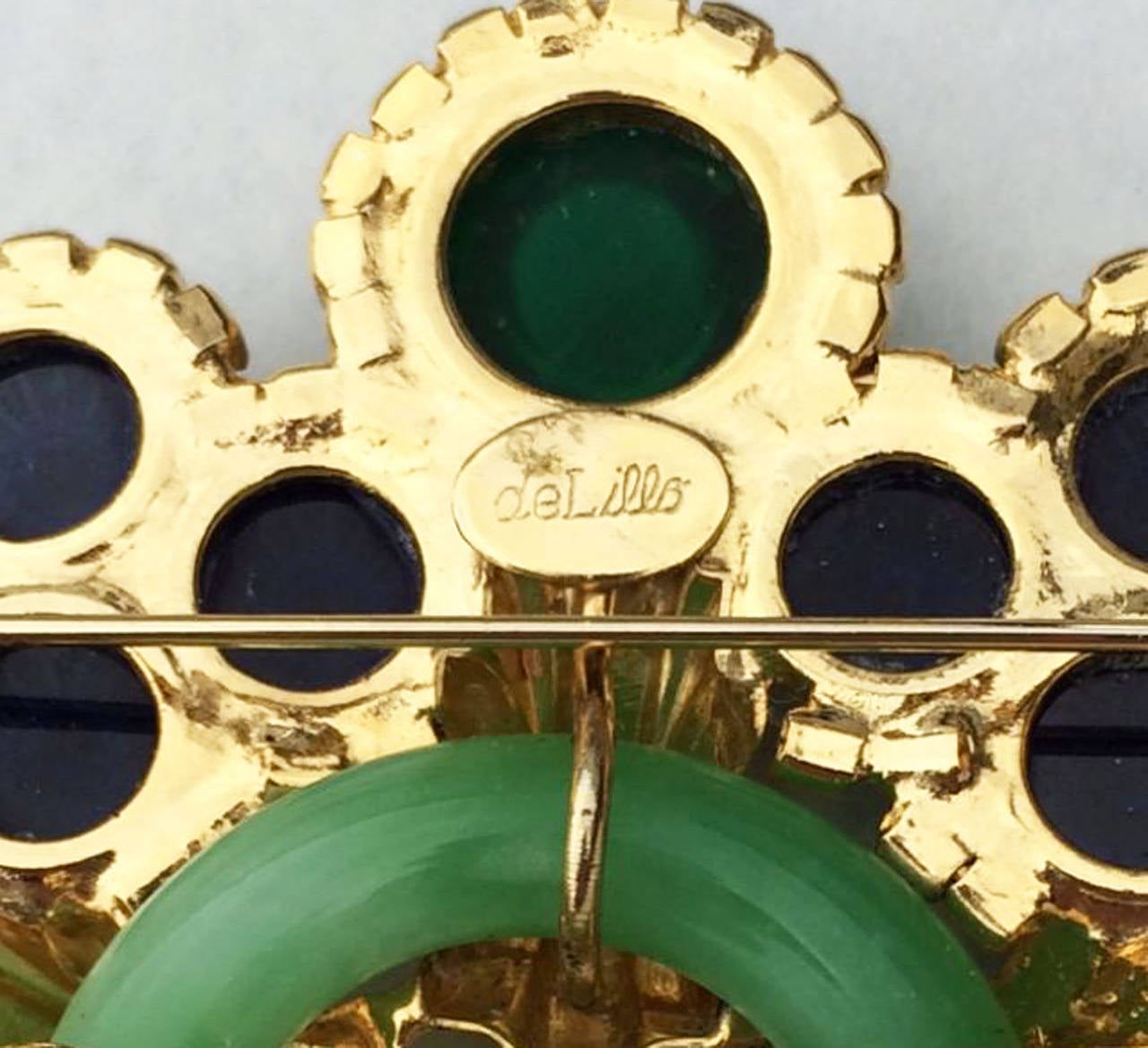 A fine and rare vintage Robert F. Clark for William de Lillo Art Deco revival brooch. Signed gilt metal item features a glass 