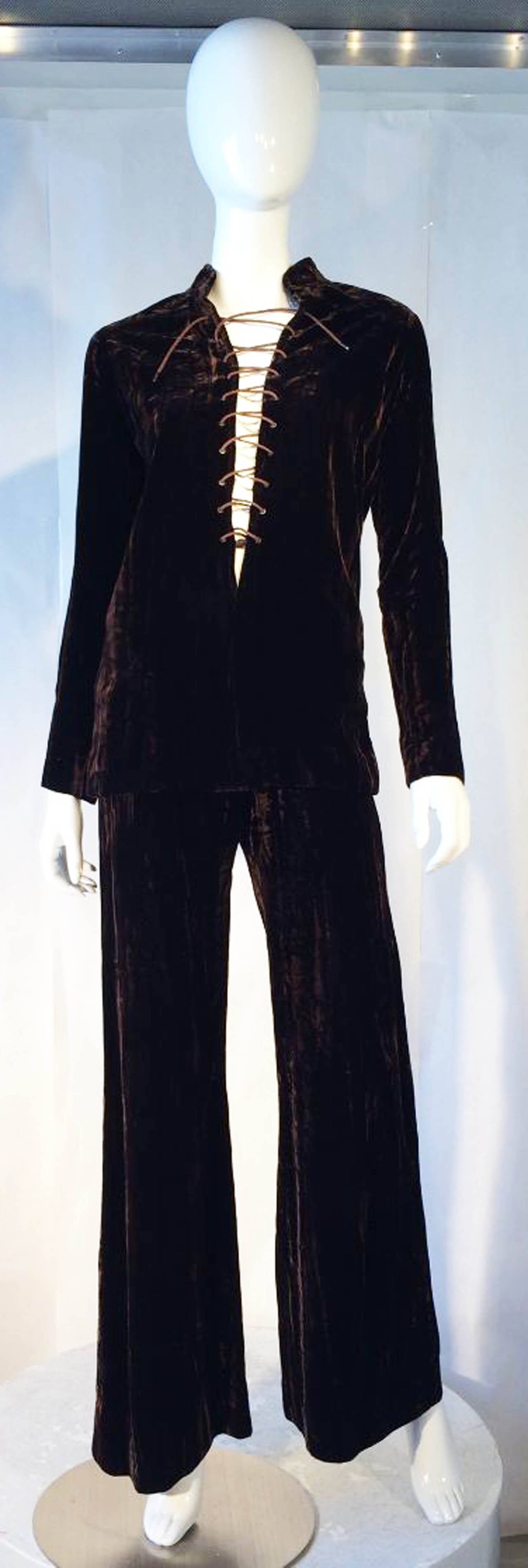 A fine and rare vintage Yves Saint Laurent trouser suit previously owned and worn by Astrid Wyman. Rich brown crushed velvet fabric item features a deeply cut 