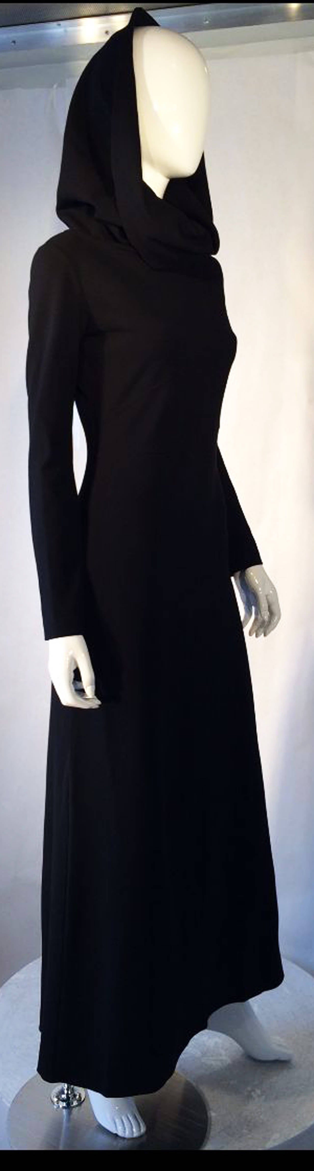 A fine vintage Claude Montana monastic gown. Black floor length heavy knit item features long sleeves and large attached funnel collar/hood. Item slips over head (no zipper). Pristine item appears unworn.