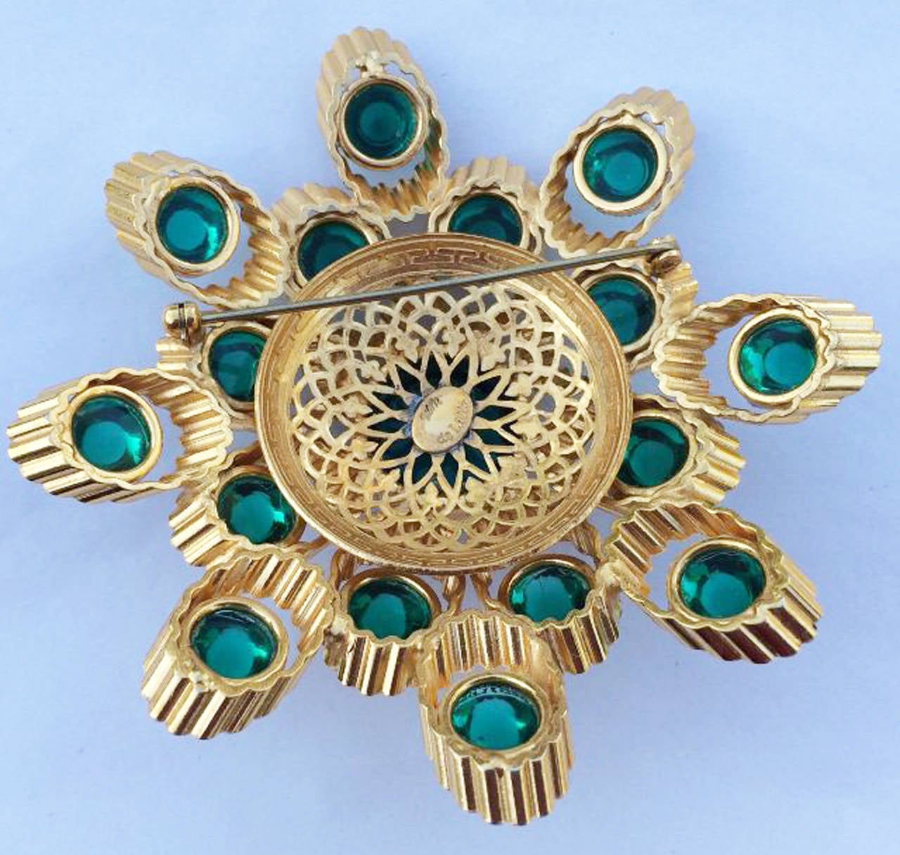 A fine and rare vintage William de Lillo brooch. Signed sculpted gilt metal item features vibrant green art glass cabochon centers. Original non-produced prototype one-off item directly from the Wm de Lillo archives. Unworn.