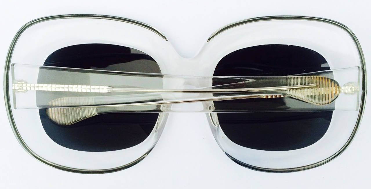 A fine vintage pair oversize clear Lucite frames sunglasses. Thick sculpted Lucite frames with original tinted grey lenses. Excellent condition (no issues).