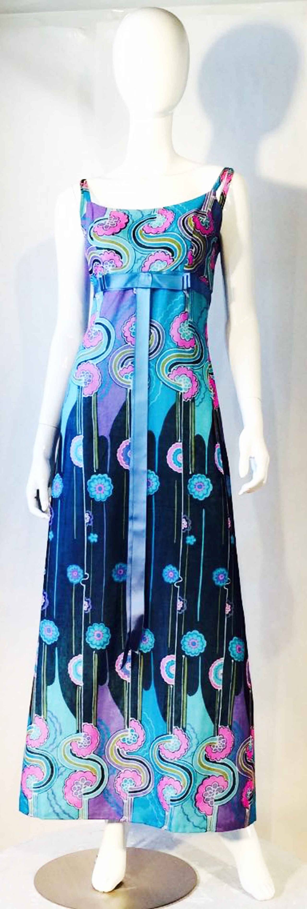 A fine and rare vintage Jean Hersey couture cocktail gown. Dynamically graphic cotton voile print item fully lined with a cinched empire waist and shoulder straps. Original attached waist bow and zipper back closure. A rarely seen Paris designer