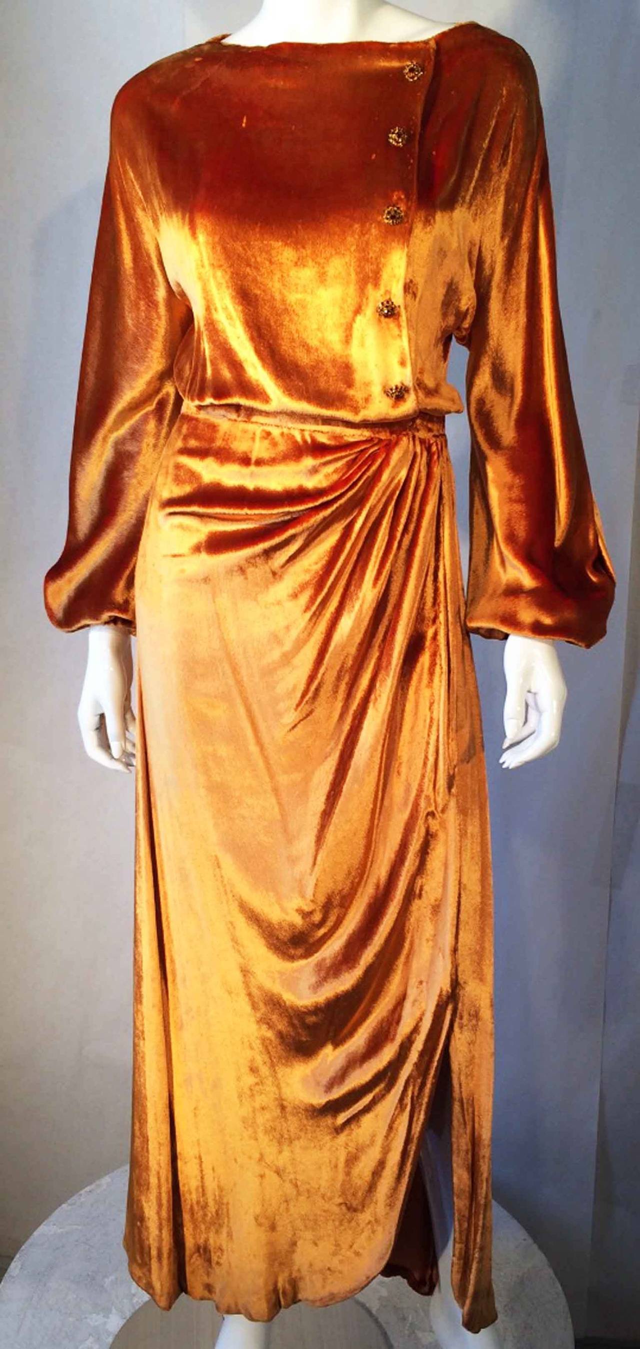 A fantastic and rare vintage Jean Patou haute couture gown. Authentic hand numbered item constructed of vivid golden panne velvet. Bias cut fabric item hand finished and features hidden snap and hook closure front. Item retains original paste set