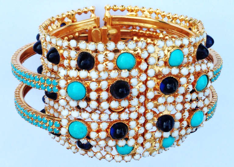 A fine and rare vintage William de Lillo clamper cuff bracelet. Rare signed gilt metal item from the designers archives features bezel set faux turquoise and 