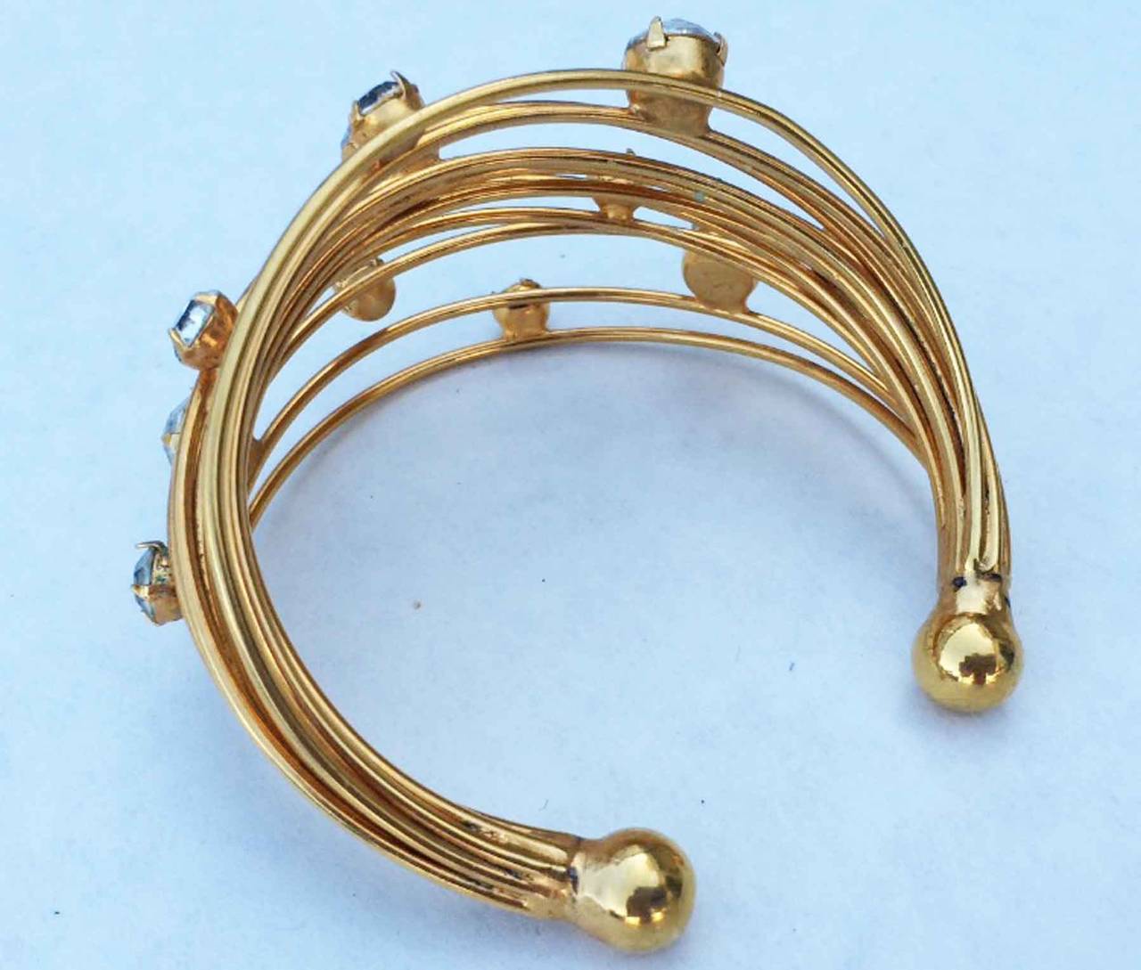 A fine vintage William de Lillo cuff bracelet. Signed gilt metal wire item set wit various size Swarovski crystals. Unworn item from the Wm. de Lillo archives.
