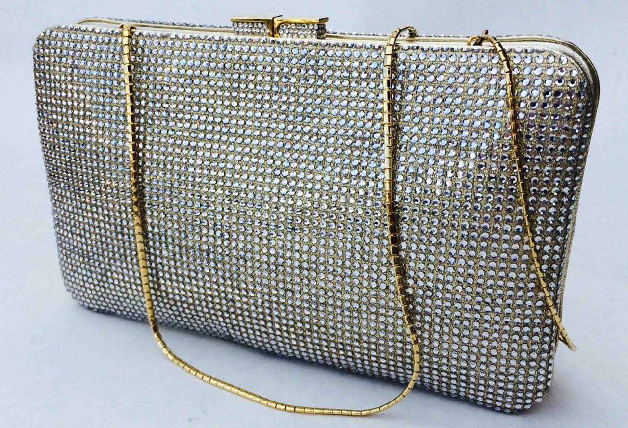 A fine and rare vintage Judith Leiber evening bag. Authentic crystal covered gilt gold leather item fully leather lined with a push clasp closure. Original gilt 14