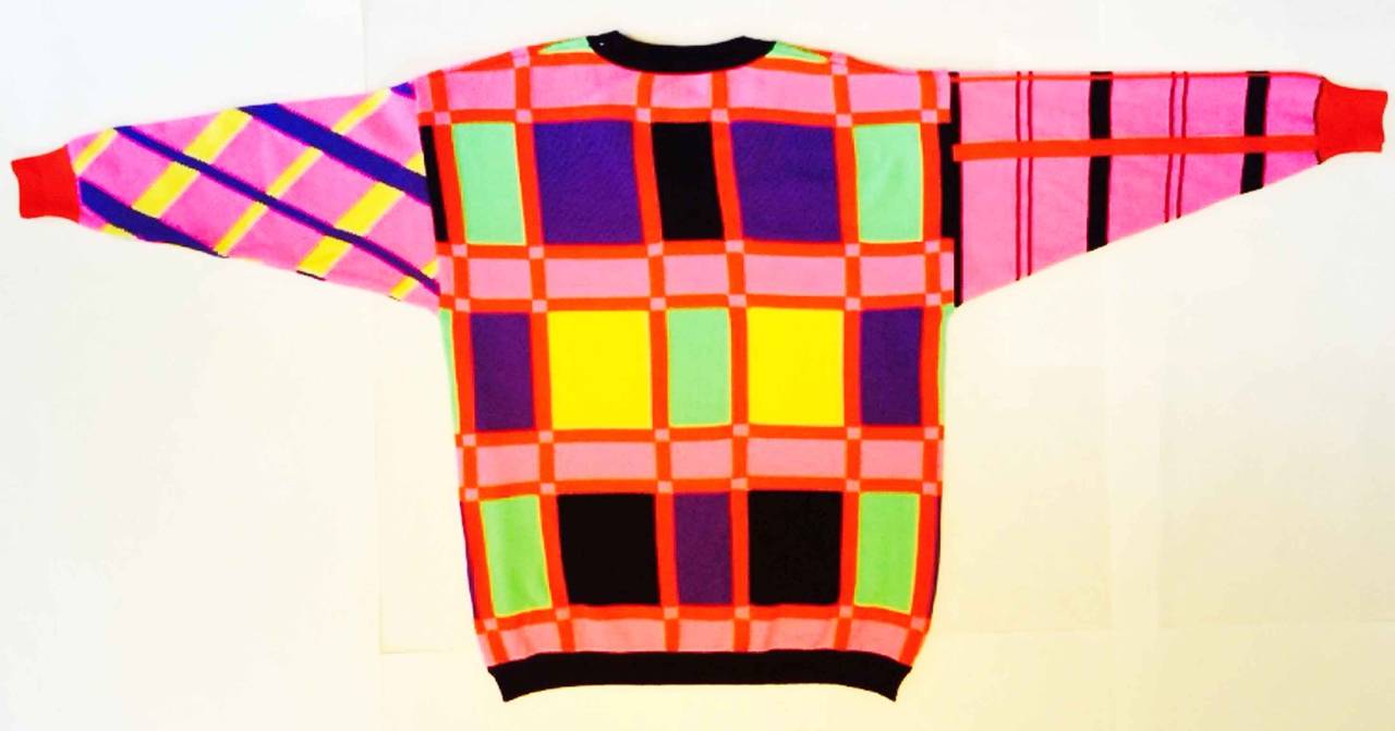 A fine gents vintage Gianni Versace color block sweater. Finest wool knit item features multi-color color block technique and black wool trim. Pristine appears unworn.