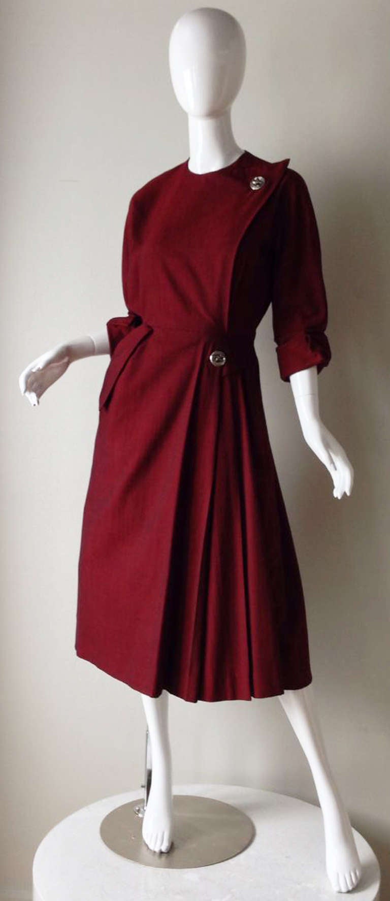 A fine and rare vintage Christian Dior afternoon/cocktail dress. Red/black woven wool fabric features precision seams, nipped waist, turned cuffs and faux 