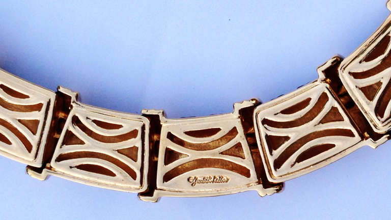A fine vintage Judith Leiber enamel collar. Signed gilt metal and black enamel linked collar after the famous version by Jean Schlumberger for Tiffany & Co. Unworn item retains original signature box. Pristine.