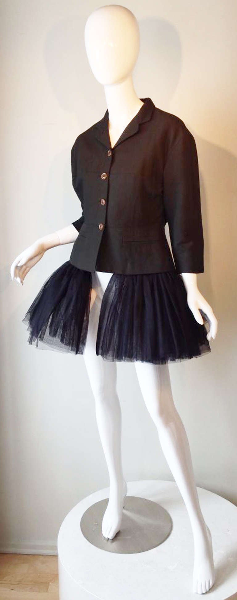 A fine and rare vintage Jean Paul Gaultier tutu jacket. Iconic item features a traditional cut blaze with a zipper attached triple layer tutu skirt. Item fully lined with button front closure. Pristine/Appears unworn.